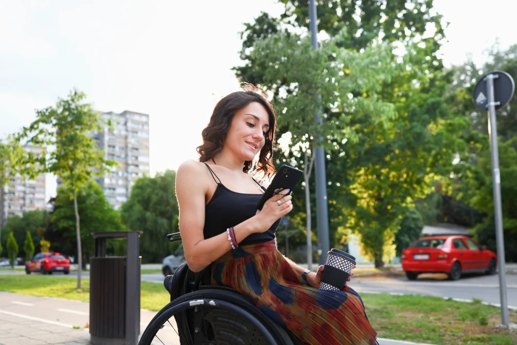Woman in wheelchair smiling and looking at camera